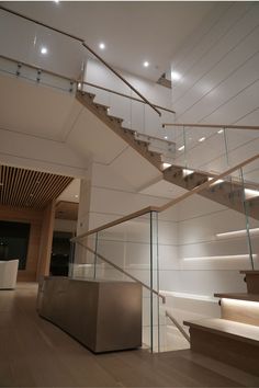 the stairs are made of glass and wood