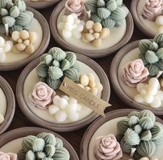 many cupcakes decorated with flowers and leaves