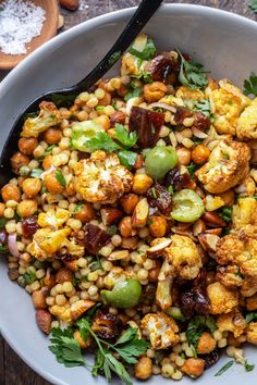 a white bowl filled with corn and vegetables