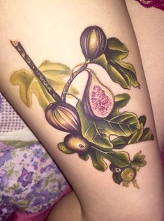 a woman's thigh with flowers and leaves on it