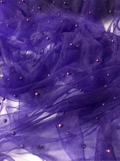 "STUNNING SOFT PEARL BEADED  BRIDAL LACE TULLE:- PURPLE IN COLOUR  WIDTH IS 60\" INCHES IT HAS BEAUTIFUL BEADS AND PEARLS ON IT SOFT BEAUTIFUL LIGHT WEIGHT FABRIC  USED FOR MULTIPLE PROJECTS  BRIDAL GOWNS,DRESSES,PARTY WEAR,COSTUMES CRAFTS,SCARFS,EMBROIDERED TOPS,UPHOLSTERY,DRAPING,DECORATIONS ETC  WE TRY OUR BEST TO GET THE ACTUAL COLOUR OF THE FABRIC BUT BECAUSE OF CAMERA EFFECTS AND DIFFERENT MONITORING SCREENS COLOURS MAY SLIGHTLY VARY  THIS PRICE IS FOR ONE METER BUT OF YOU WILL BUY MORE TH Gown Dress Party Wear, Purple Tulle, Embroidered Tops, Camera Effects, Party Kleidung, Scarf Dress, Bright Purple, Dresses Party, Bridal Lace