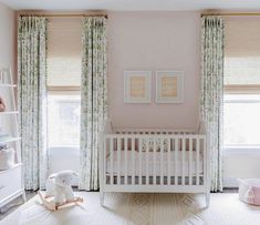 a baby's room with pink walls and curtains