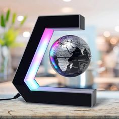 an illuminated globe sits on top of a table