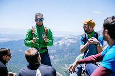 a group of people sitting on top of a mountain