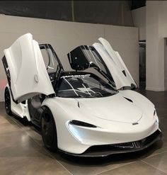 a white sports car with its doors open