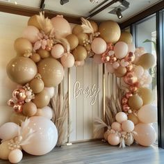 an arch made out of balloons and flowers