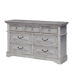 an old white dresser with drawers on it