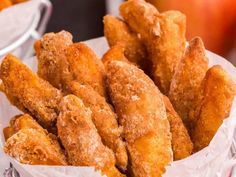 fried chicken sticks in a basket next to an apple