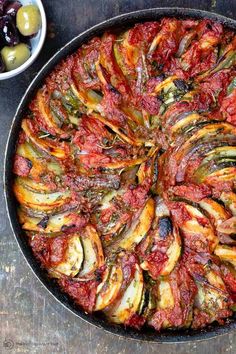 a pan filled with cooked vegetables on top of a table