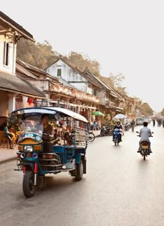 people are riding motorcycles and scooters down the street