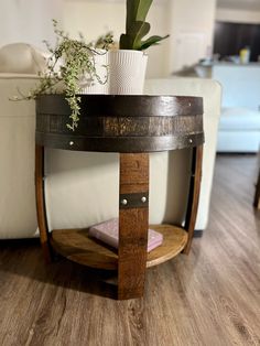 a potted plant sitting on top of a wooden table next to a white couch