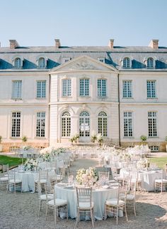 a large white building with many tables and chairs