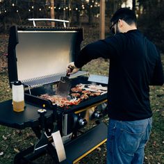 a man grilling food on an outdoor bbq