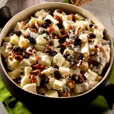 a bowl filled with fruit and nuts on top of a table