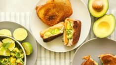 avocado, toasted bread and salad are on plates next to each other