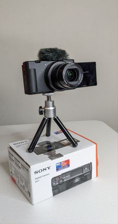 sony zv-1 on top of its box on a tripod. the wind guard is attached and the lens is open. Sony Zv1 Aesthetic, Sony Zv1 Camera, Gaming Camera, Electronics Branding, Sony Zv1, Sony Video Camera, Best Vlogging Camera, Start Youtube Channel, Best Cameras