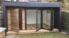 an outdoor room with sliding glass doors on the outside