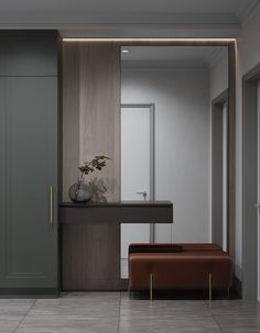 an empty room with a bench, mirror and vase on the counter in front of it