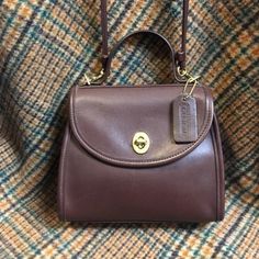 A Beautiful 1990s Coach 'Regina' Crossbody Bag In Mahogany Brown. Bag Features A Crossbody Strap With Brass Hardware, Rear Slip Pocket, Front Flap With Top Handle And Turn Lock Closure. Interior Has A Large Main Compartment With Small Zippered Pocket. Made From Thick And Buttery Soft Glove Tanned Leather In Brown. Bag Is Marked With The Coach Creed And Stamped Designates This Bag As The 'Regina' Style, This Particular Bag Was Made In 1988. Original Hang Tag Is Included. Brand: Coach Material: Glove Tanned Leather, Brass Hardware Condition: Excellent The Leather Is Soft And Supple Approx Measurements: Width: 7.75" Height (Without Strap): 7" Depth: 3.75" Length Of Strap (Without Hardware): Dream Wishlist, Soft Gloves, Mahogany Brown, Vintage Coach Bags, Brown Purse, Brown Bag, Brown Purses, Vintage Coach, Brass Hardware