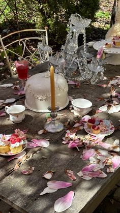 a table topped with cake and plates covered in leaves