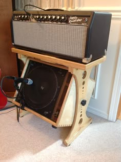 an amp stands next to a red guitar