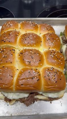 a sandwich with meat and cheese on it in a baking pan, ready to be baked