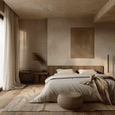 a large bed sitting next to a window in a bedroom on top of a hard wood floor