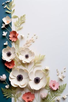 an arrangement of paper flowers on a blue and white background