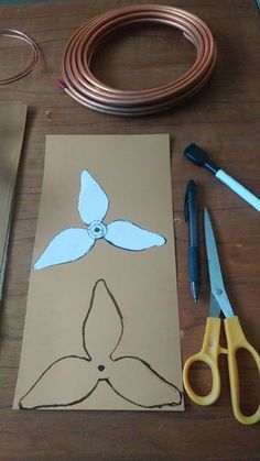 the paper is cut out to look like a flower and scissors are next to it