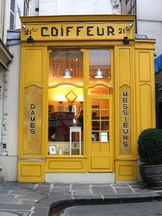 a yellow storefront with the words coiffeur on it