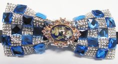 "Beautiful pre-tied and adjustable double tiered banded bow tie Crystal Beaded Will adjust from 13\" through 20\" neck. Bow dimensions 2.5\" x 4.5\". Bow tie Always made by hand and to your special order. Weddings and groups are welcome." Blue Bow Tie With Ribbon As A Gift, Blue Adjustable Bow Tie And Suit Accessories, Elegant Blue Bow Tie With Detachable Bow, Blue Bow With Butterfly Knot For Wedding, Blue Ribbon Bow For Party, Blue Wedding Bow With Butterfly Knot, Blue Party Bow With Ribbon, Adjustable Blue Bow With Bow Tie Back, Elegant Blue Ribbon Bow