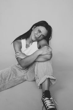 a woman sitting on the floor with her arms crossed