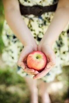 a person holding an apple in their hands