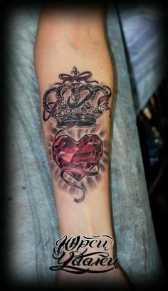 a man with a crown and heart tattoo on his arm that says, queen victoria