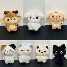 six different stuffed animals sitting on top of a black table next to each other,