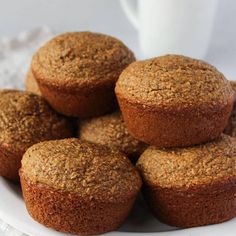 a white plate topped with muffins next to a cup of coffee