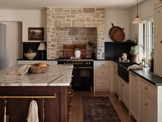 a kitchen with an oven, sink and counter tops in it's center island