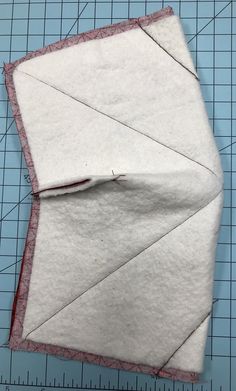 a piece of fabric is laying on top of a cutting mat