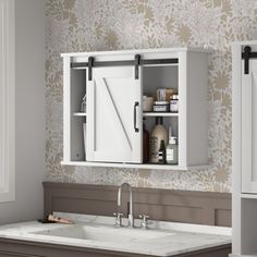 a bathroom with a sink, mirror and medicine cabinet