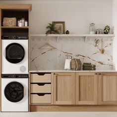 a washer and dryer sitting in a kitchen next to each other on top of wooden cabinets