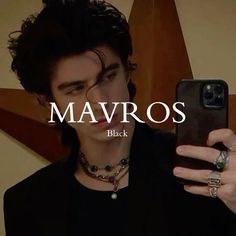 a young man holding up his cell phone to take a selfie with the caption'mavros black '