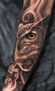 an owl tattoo on the arm is shown