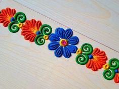 a colorful flower design on a wooden surface