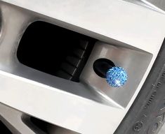 a close up of a car's front wheel hubs with blue glitter on them