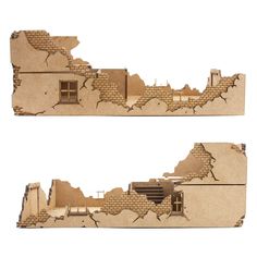 two pieces of cardboard that have been cut out to look like a house with broken windows