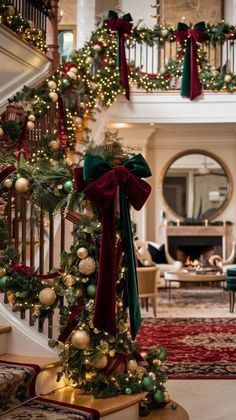 christmas decorations on the banisters and stairs in a house with red carpeting