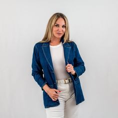 Discover the perfect blend of casual and polished with our chic structured denim blazer. Designed for the fashion-forward woman, this versatile denim jacket offers a sophisticated silhouette with notched lapels and a contemporary tailored fit. It's an ideal piece for those seeking a casual sophisticated denim blazer that transitions effortlessly from day to night. Affordable Spring Denim Blazer, Workwear Denim Jacket With Lapel Collar, Denim Blue Outerwear For Work With Double Button, Denim Blue Outerwear With Double Button Closure For Work, Formal Denim Blazer For Spring, Chic Fitted Denim Jacket For Everyday, Spring Formal Denim Blazer, Classic Medium Wash Blazer With Pockets, Medium Wash Lapel Collar Outerwear For Work