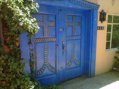 an image of a blue door in front of a house