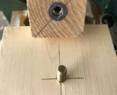 a piece of wood that is being worked on with a drill and some screws