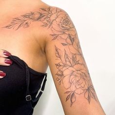 a woman's arm with flowers on it